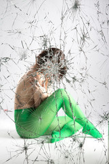 Woman behind a broken window