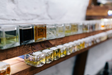 Close up color bottles on the shelf in old perfume laboratory. Flasks and examples of odor in the perfume laboratory and shop