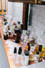 Close up amber color bottles on the shelf in old perfume laboratory. Flasks and examples of odor in the perfume shop.