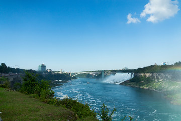 Panorama view of Niagara falls with boat cruising on river