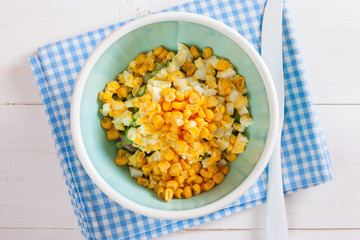Step by step cooking salad with smoked chicken, corn, crackers, step 4 - adding ingredients - canned corn, top view, horizontal