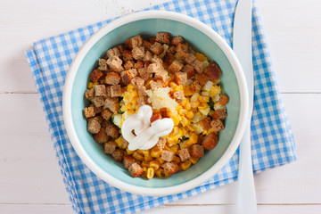 Step by step cooking salad with smoked chicken, corn, crackers, step 6 - adding ingredients - mayonnaise and garlic, top view, horizontal