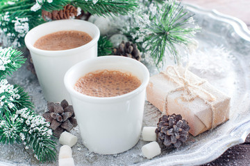 Obraz na płótnie Canvas Hot chocolate in white glasses on a tray with New Year's decor, horizontal, copy space