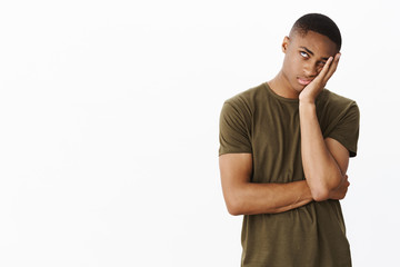Portrait of annoyed and displeased african american handsome young guy rolling eye up...