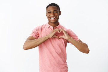Wais-up shot of sincere kind and cute african american young male sharing love and tender feelings...