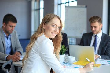 business woman with her staff, people group in background at modern bright office indoors.