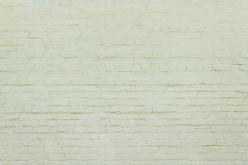 Fototapeta premium Yellow brick wall background. brick wall of colored stone texture