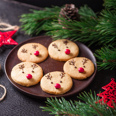 Homemade deer cookies decorated chocolate and red candies Soft focus Greeting card