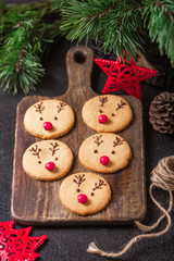 Homemade deer cookies decorated chocolate and red candies Soft focus Greeting card