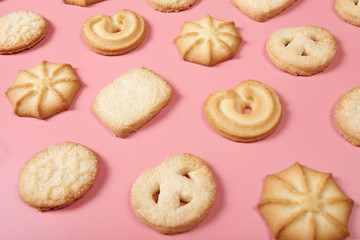 Danis butter cookies on pink background. Close-up.