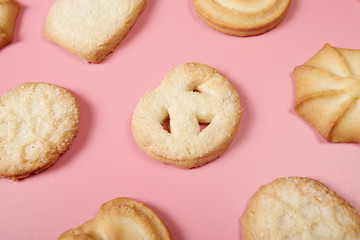 Danis butter cookies on pink background. Close-up.