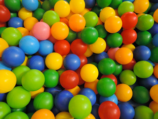 Multi-colored plastic balls for dry pool, top view.