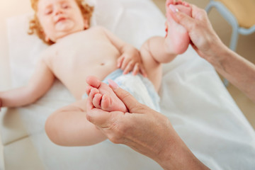 Friendly doctor pediatrician with patient child at clinic