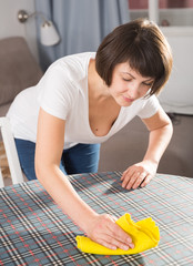 Cheerful woman doing housework