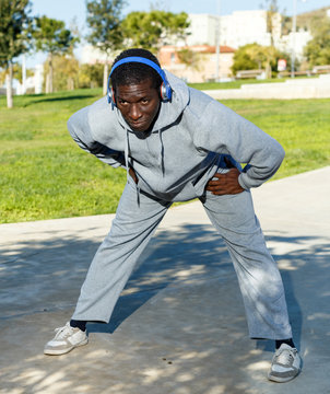 Active african  american man doing workout in park at sunny day