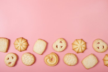 Danish butter cookies on pink background with copy space. Top view.