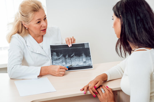Doctor get examining breast of young woman. Consultation with gynecologist.