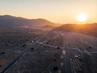 Desert road at sunset aerial view
