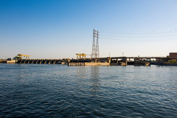 Naklejka premium Landscape view of large dam with lock on river nile in Egypt