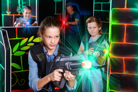 Portrait of teenager girl with laser gun having fun with her fam