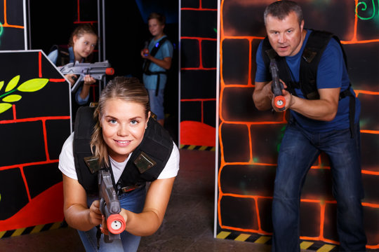 Woman playing lasertag with family