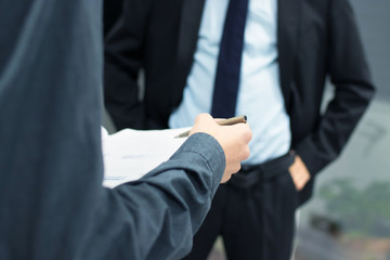 business people with documents and signing the contract
