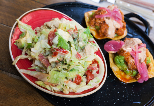 Image of tasty chicken salad with avocado and tuna tostada