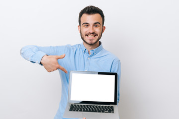Photo of happy young man pointing at his online prize