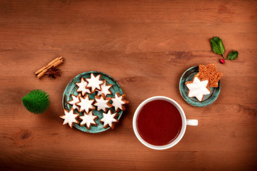 Obraz na płótnie Canvas A Christmas greeting card with star biscuits and hot chocolate on a wooden background with a place for text