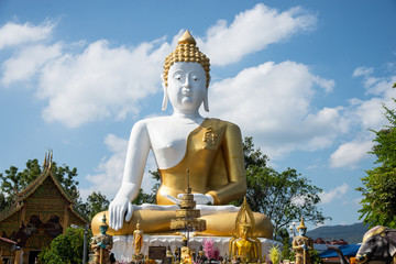 Fototapeta premium Buddha statue (Thai: Luang Por Tan Jai ) in Wat Phra Tat Doi Kum, The Buddhist temple in Chiang Mai, northern Thailand