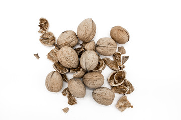 Walnuts on a white background, broken by a nutcracker