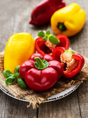 Plate with Bell peppers on a wooden background