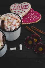 Fototapeta na wymiar Romantic breakfast for valentine day. A delicious drink of marshmallows and heart-shaped cookies. Breakfast for lovers on a wooden table