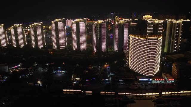 night illuminated sanya bay riverside apartment complex aerial panorama 4k hainan island china
