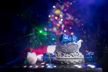 Dj mixer with headphones on dark nightclub background with Christmas tree New Year Eve. Close up...