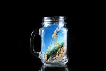 abstraction sea wave in the bottle on black background