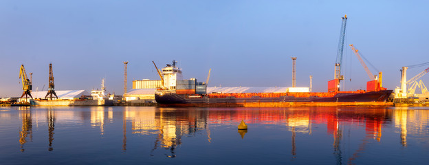 ship in the sea port,port cranes unloading containers-panorama