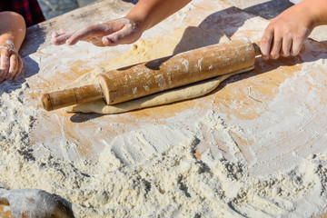 Woman rolling dough with rolling pin