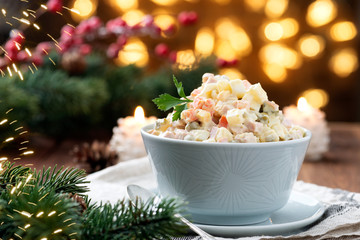 Russian traditional salad Olivier with vegetables and meat. Winter salad 