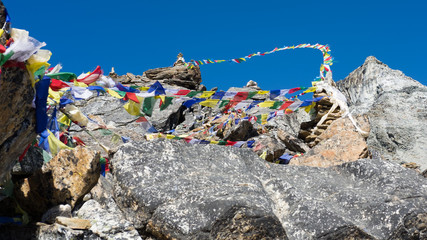 buddist prayer flags on renjo la pass, himalayas nepal
