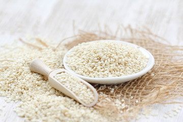Sesame seeds in a bowl on a wooden table