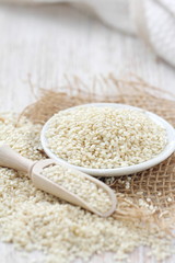 Sesame seeds in a bowl on a wooden table