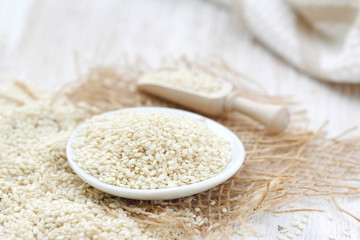 Sesame seeds in a bowl on a wooden table