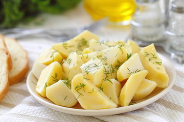 Boiled potatoes with greens and oil
