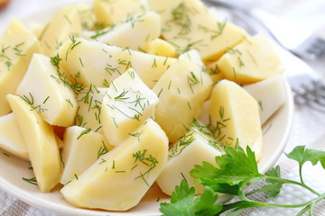 Boiled potatoes with greens and oil