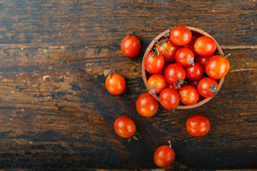 Fototapeta na wymiar cherry tomatoes on wooden background