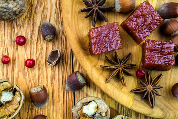 Hazelnuts and walnuts, sweets are on the old brown table.