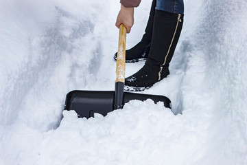 People cleans snow shovel on the street, close-up