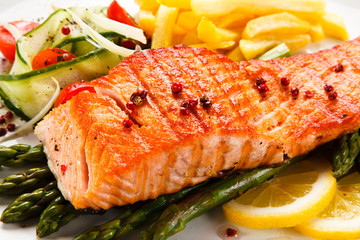 Grilled salmon, French fries and vegetables