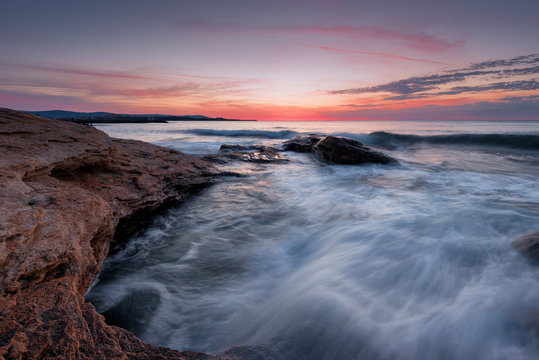 Seascape during sunrise. Beautiful natural seascape. Sea sunrise at the Black Sea coast. Magnificent sunrise with clouds and fire sun at the beginning of April.Ravda, Bulgaria